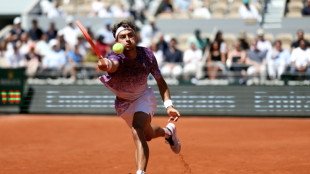 Cobolli fights into French Open last eight against dogged Svajda